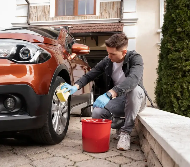 Lavage auto à domicile Hitte : professionnel intervenant sur un véhicule